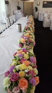 Long and low wedding flowers for your top table by Rugeley Florist - Rugeley Floral Studio Fine Flowers
