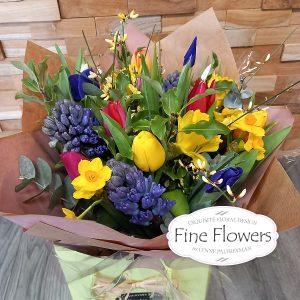 Hand-tied in water/bag of florist choice with spring flowers including iris, tulips, daffodils, hyacinths and a lovely mix of foliages