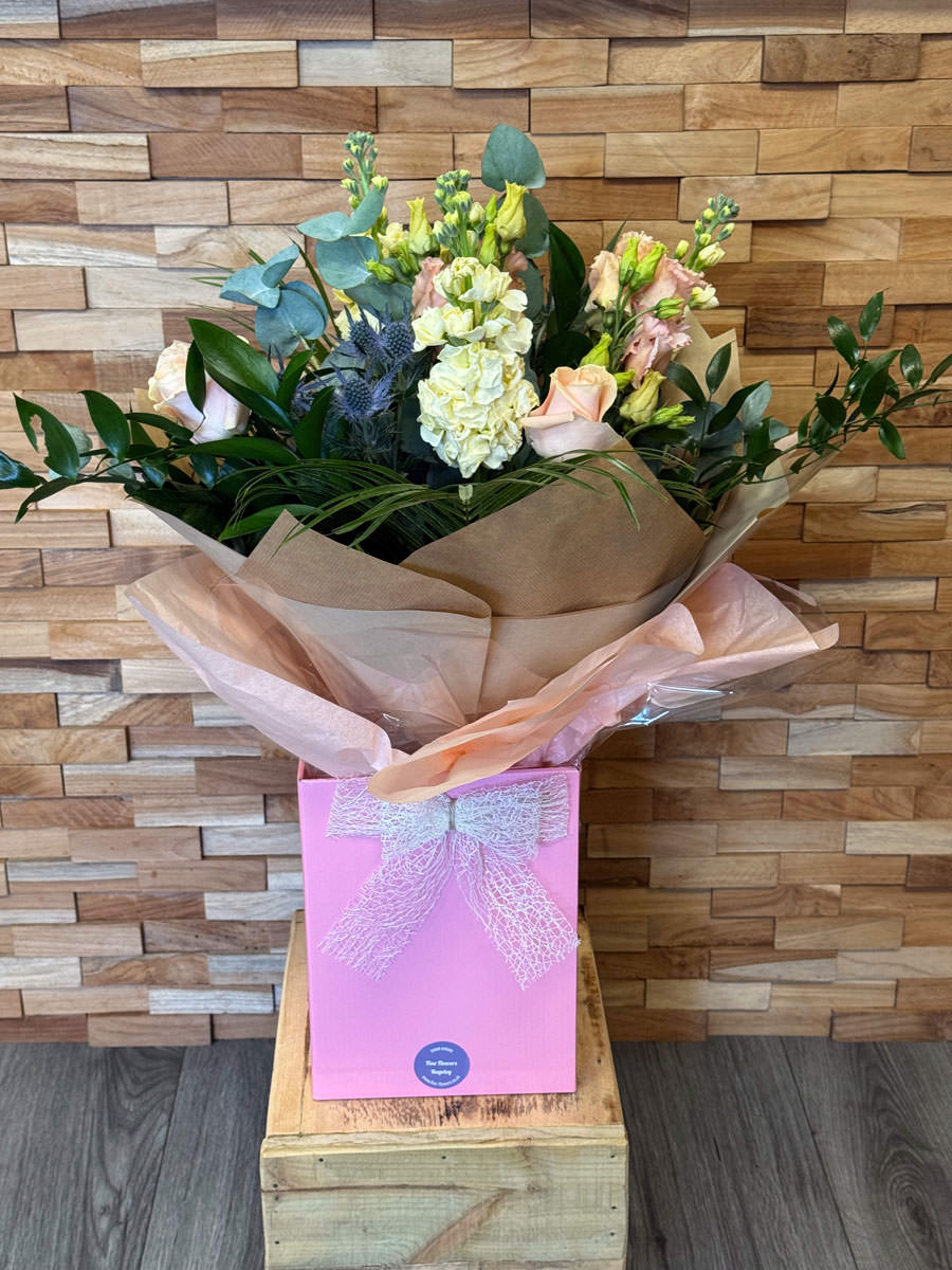 Handtied bouquet of Apricot Rose, Cream Stocks, Apricot Lisianthus, Blue Thistle.