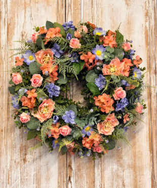 Coral Wreath featuring Hydrangeas, Cosmos, Roses, Delphinium, Mixed foliages including ferns and Eucalyptus.