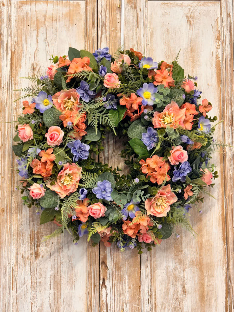 Coral Wreath featuring Hydrangeas, Cosmos, Roses, Delphinium, Mixed foliages including ferns and Eucalyptus.