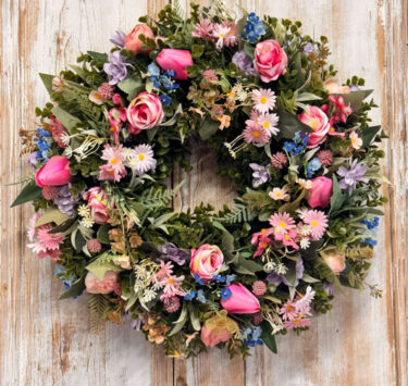 Daisy Wreath featuring Tulips, Roses, Daisys, Forget-me-not, Ranunculus, Mixed foliages including ferns and Eucalyptus.
