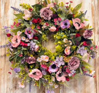 Enchanted Wreath featuring Anemones, Roses, Lavender, Ranunculus, Mixed foliages including ferns and Eucalyptus.