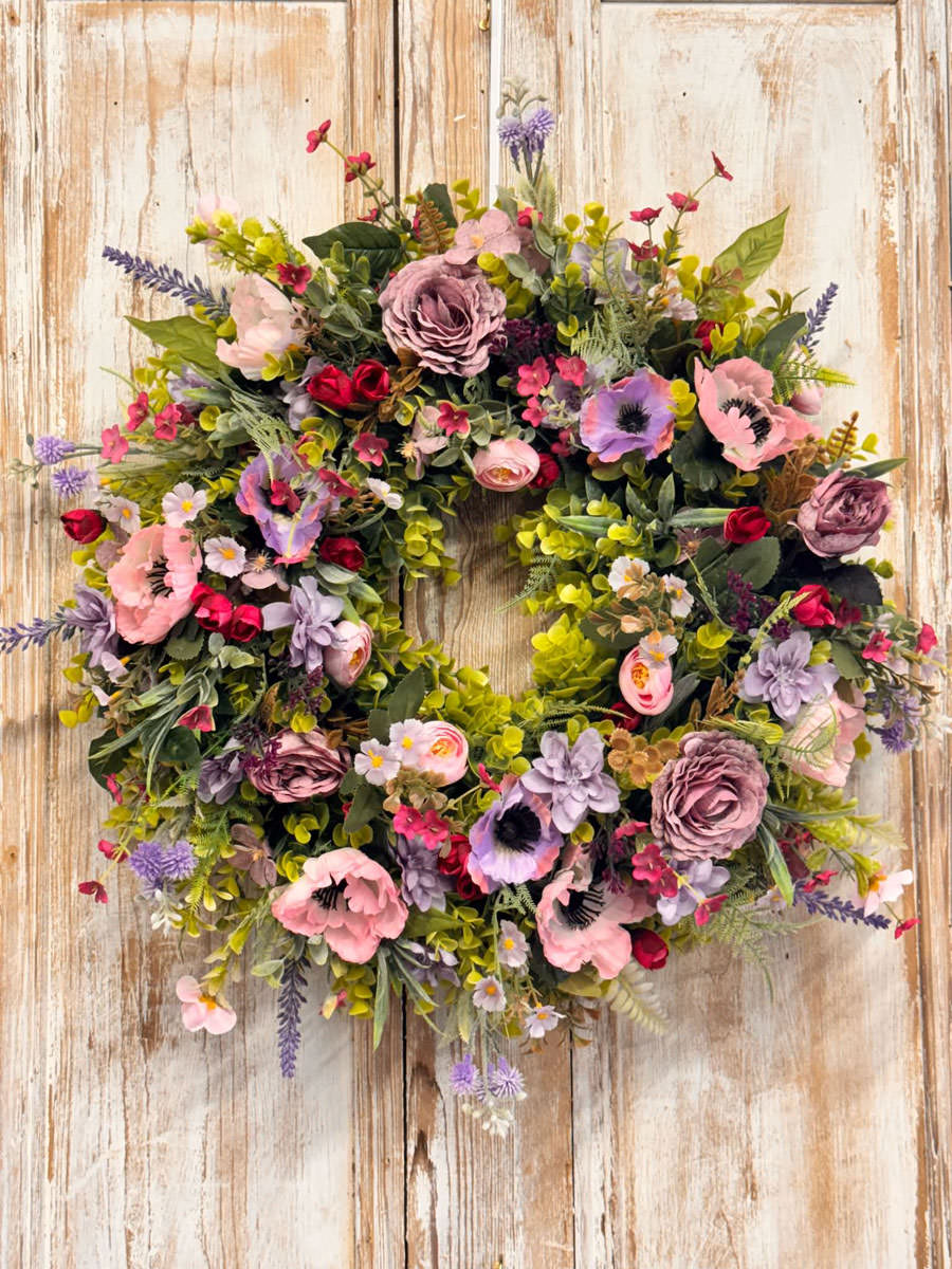 Enchanted Wreath featuring Anemones, Roses, Lavender, Ranunculus, Mixed foliages including ferns and Eucalyptus.