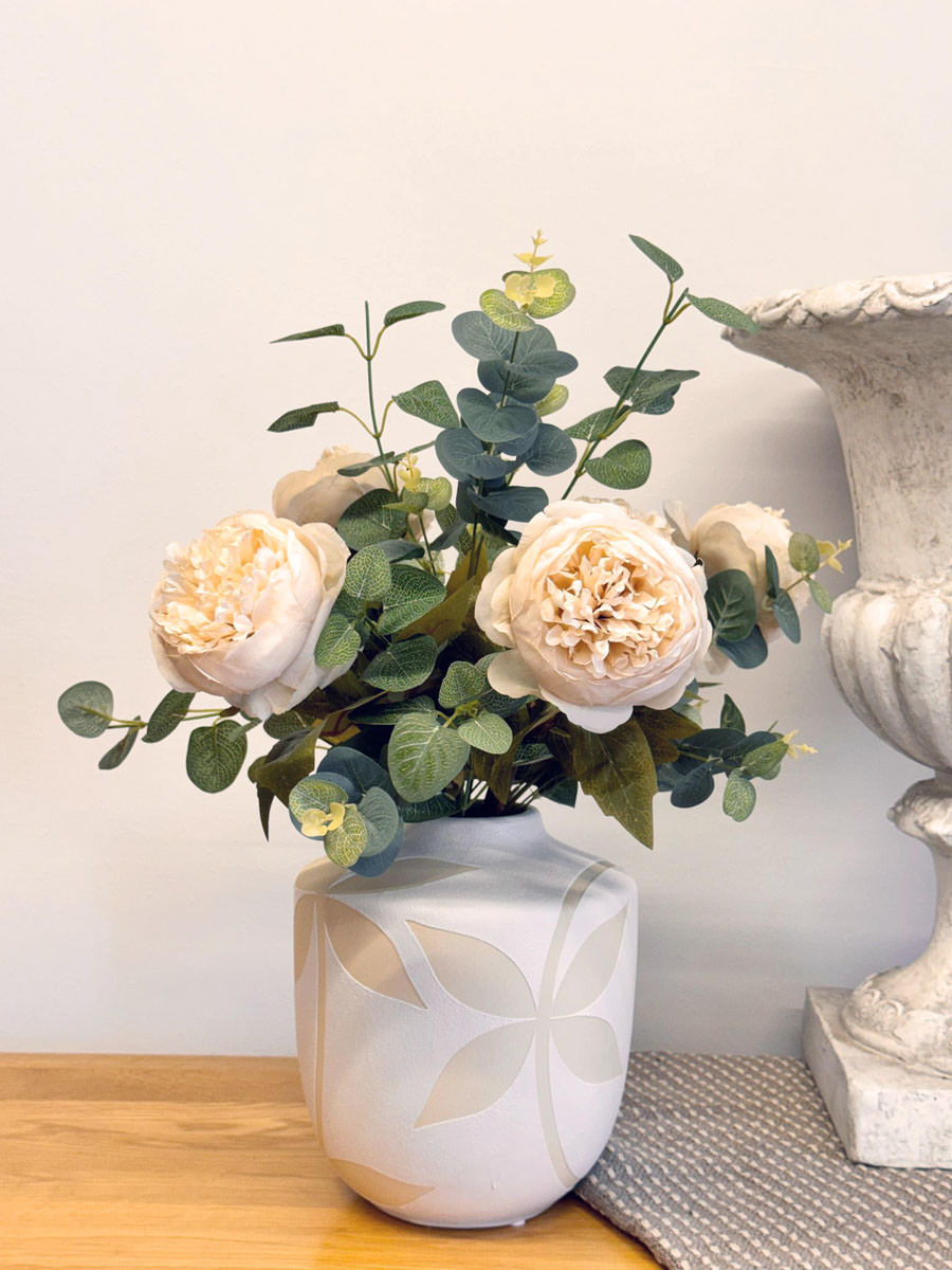 Peony Vase with 5x Cream peonies with eucalyptus foliage, presented in a detailed cream embossed leaf vase.