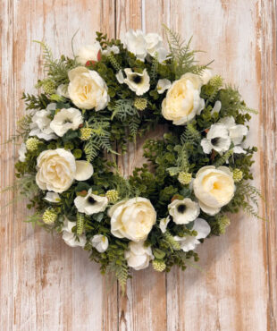Purity wreath featuring White Peony, Anemone, Hydrangeas, Mixed foliages including ferns and Eucalyptus.