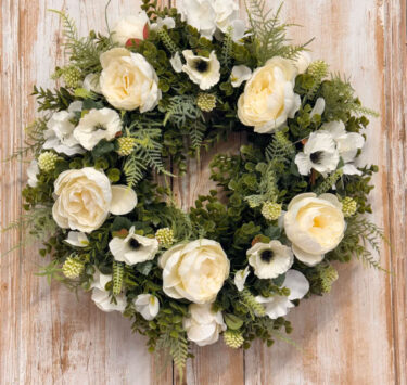 Purity wreath featuring White Peony, Anemone, Hydrangeas, Mixed foliages including ferns and Eucalyptus.
