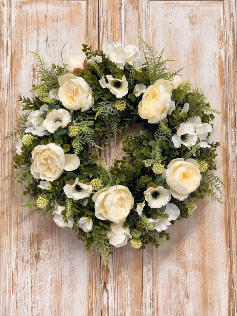 Purity wreath featuring White Peony, Anemone, Hydrangeas, Mixed foliages including ferns and Eucalyptus.
