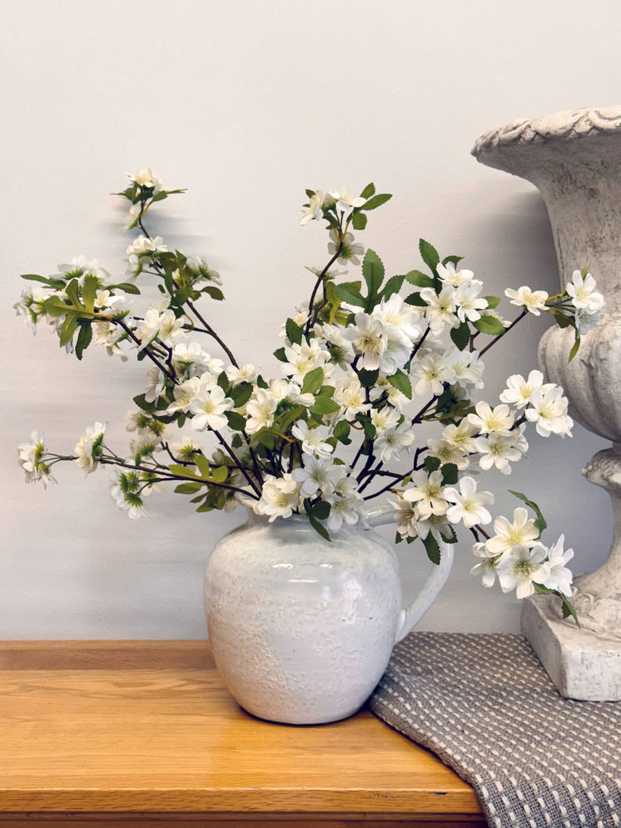 Simplicity - A cream ceramic jug with white silk blossom stems