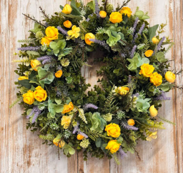 Coastal wreath featuring Yellow Roses, Ranunculus, Lavender, Heather, Mixed foliages including ferns and Eucalyptus.