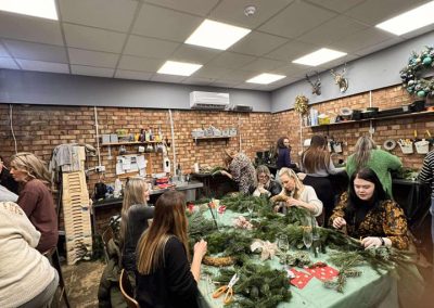 All materials provided, with music, refreshments, and a lot of Christmas cheer, you can see the workshop packed with people making Christmas Wreaths
