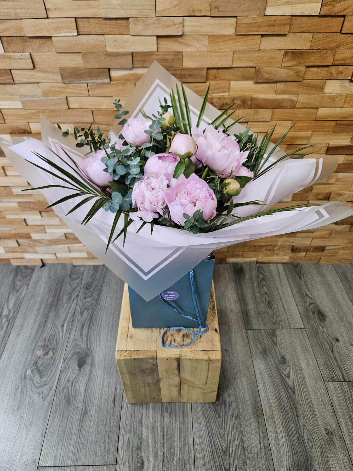 A stunning bouquet of 10 seasonal pink peonies, hand-tied and delivered in water. Classic, elegant, and perfect for any occasion.