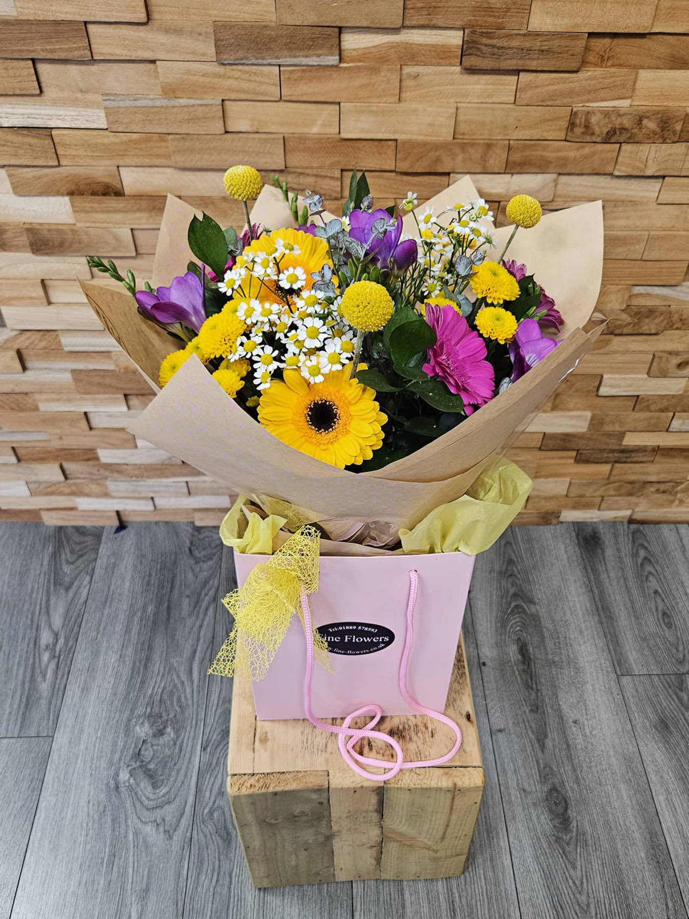 Bright and breezy! Summer Breeze mixes gerbera, crespedia, daisies, freesia, and foliage in water. Hand-tied and locally delivered.