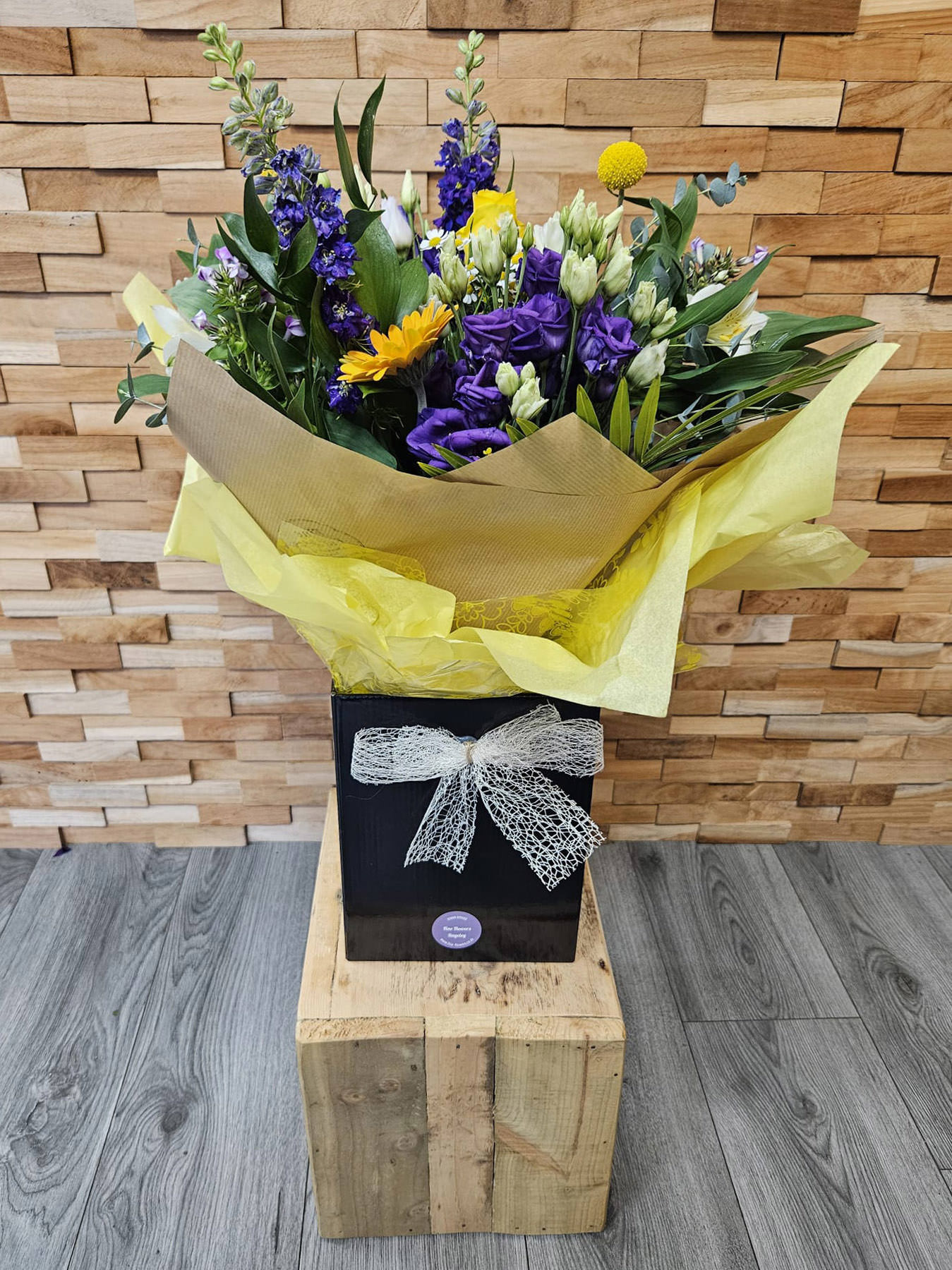 Sunset Meadow is a vibrant mix of delphiniums, lisianthus, gerbera, roses, daisies, and foliage. Hand-tied and locally delivered across Staffordshire.